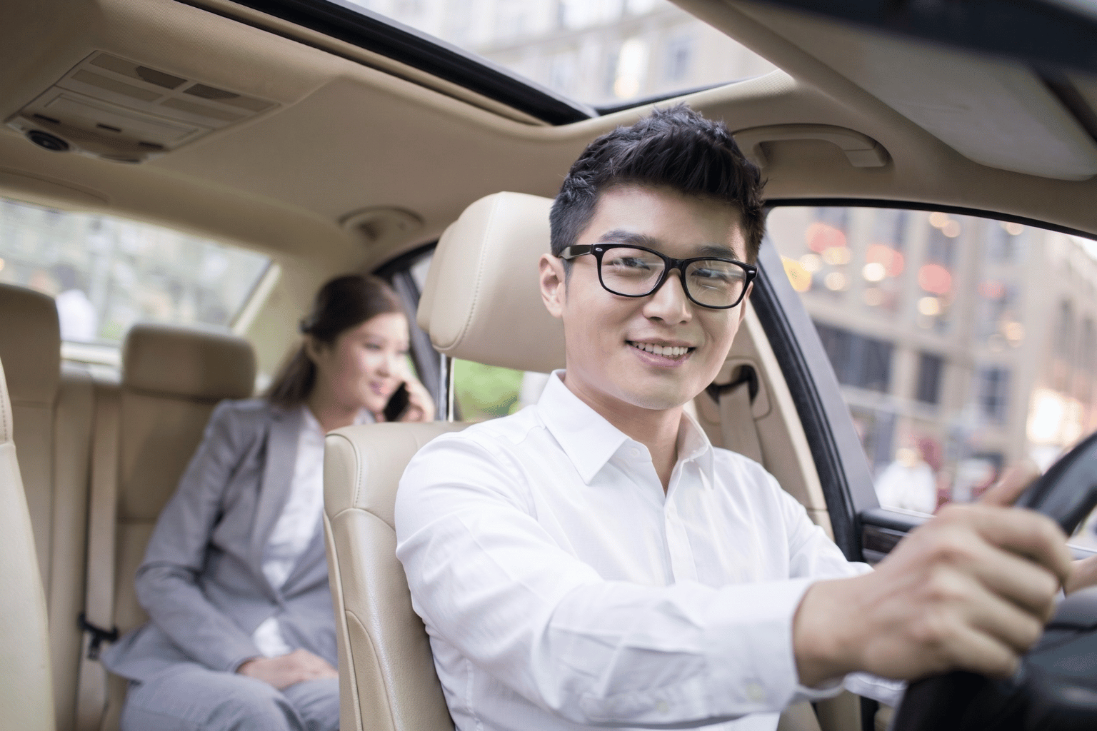 Professional Zen Rides chauffeur driving a passenger in a premium vehicle