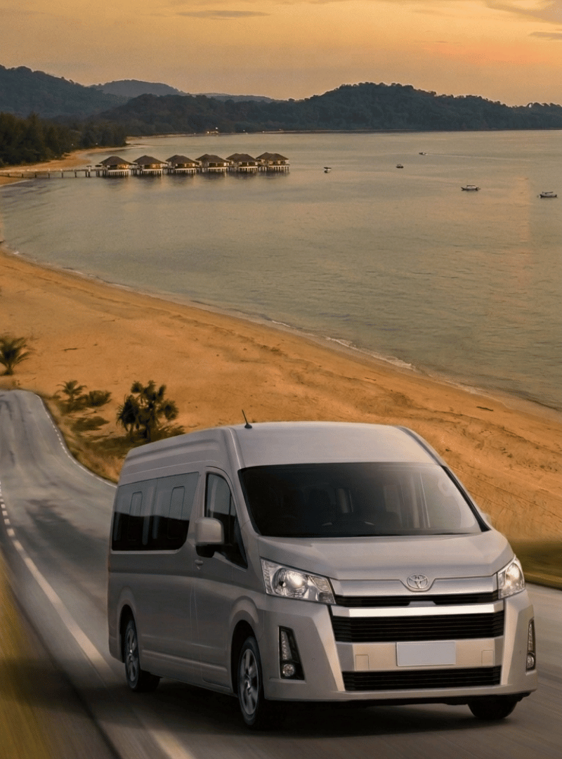 Zen Rides van on a coastal Malaysian highway at sunset