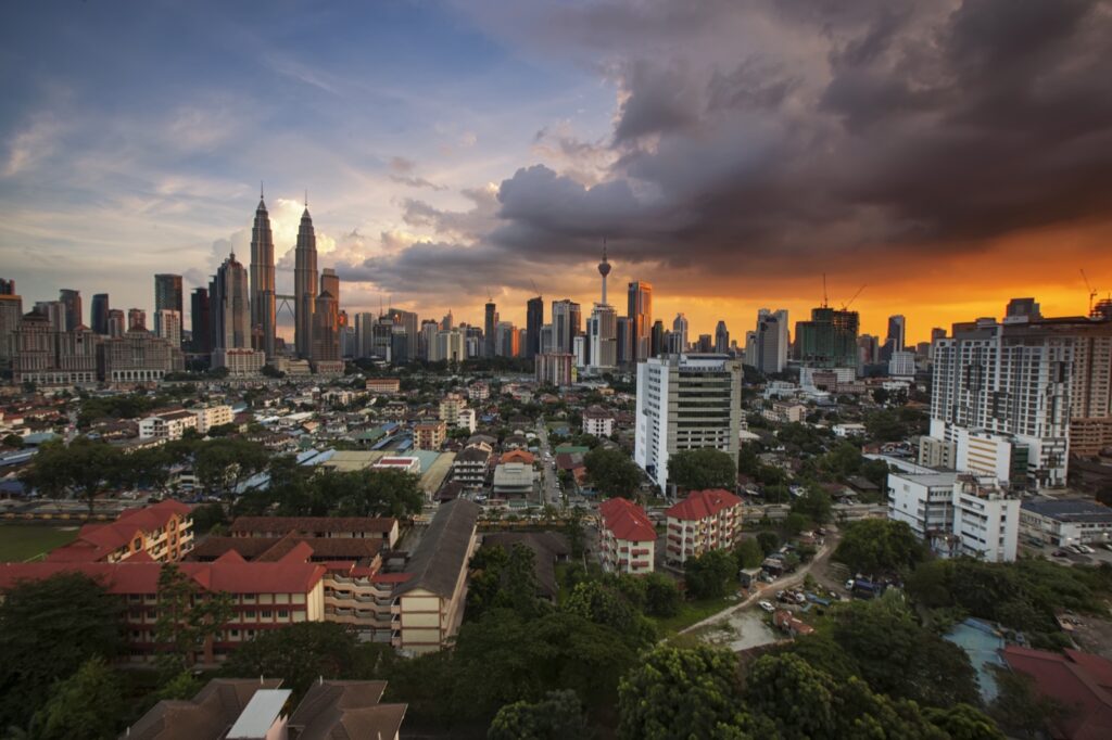 Kuala Lumpur city skyline at dusk with Petronas Towers