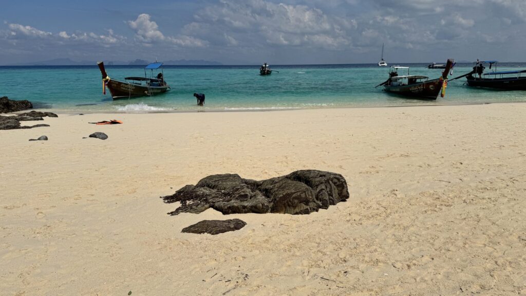 Turquoise sea and white-sand beach with boats, Malaysian islands